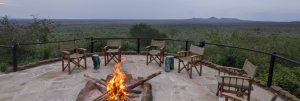 Campfire at a safari lodge in Kenya with a panoramic view of the landscape