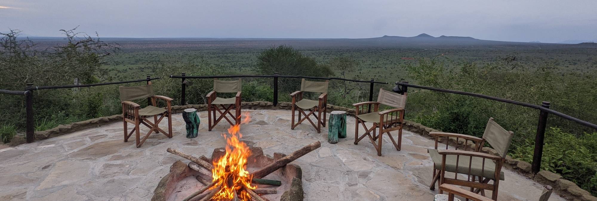Campfire at a safari lodge in Kenya with a panoramic view of the landscape